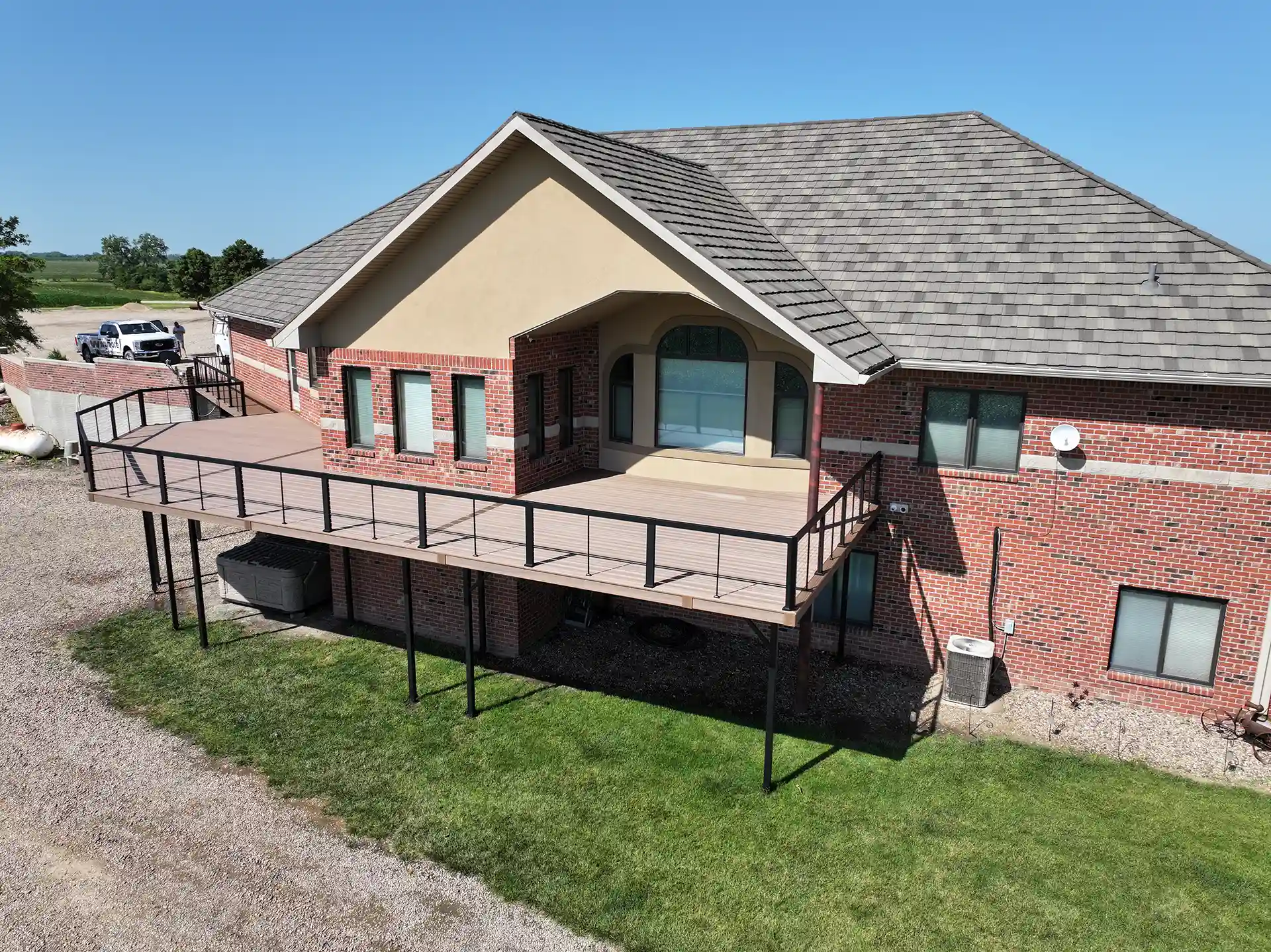 Photo of an expansive elevated, multi-level deck with cable railing.