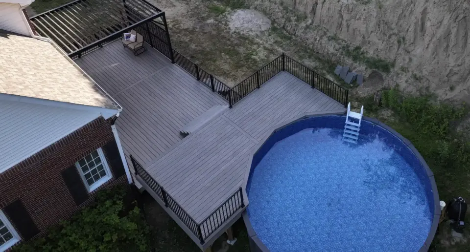 Aerial view of a multi-level deck, pool deck, and pergola by Wymore Deck & Fence, deck builders in Omaha.