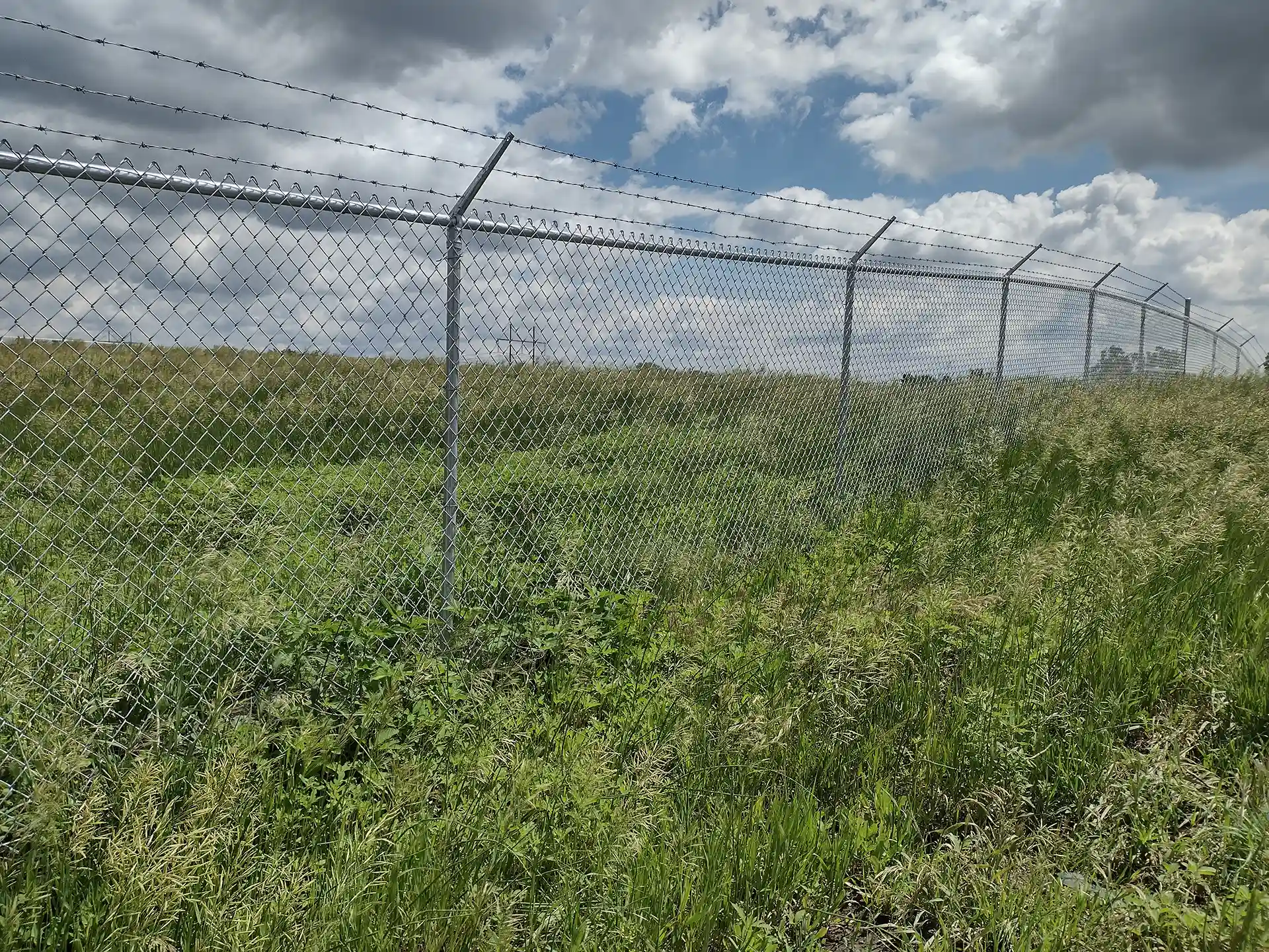 Photo of a chain link security fence by Wymore Deck & Fence, a fence contractor in West Omaha.