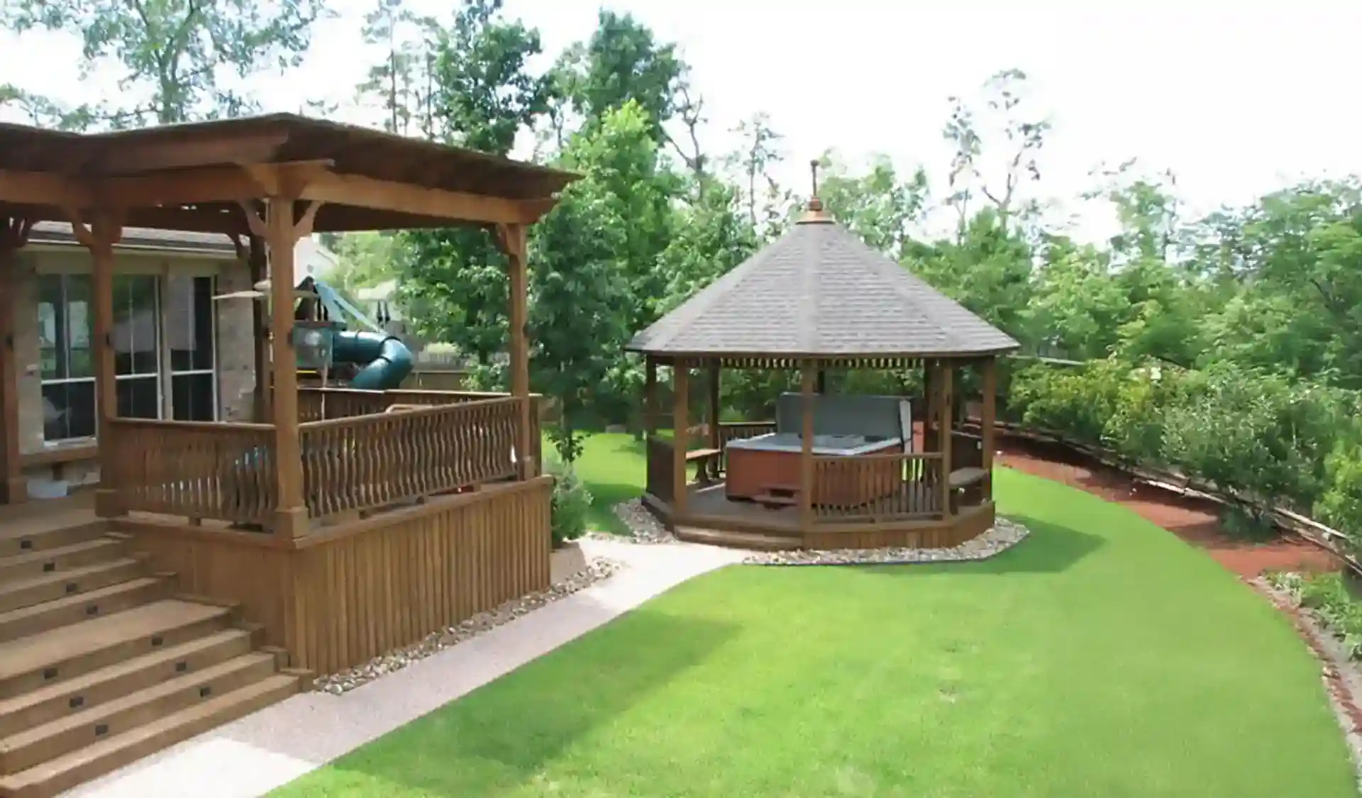 raised deck with a wooden pergola and freestanding gazebo - What is a gazebo - pergola vs gazebo comparison