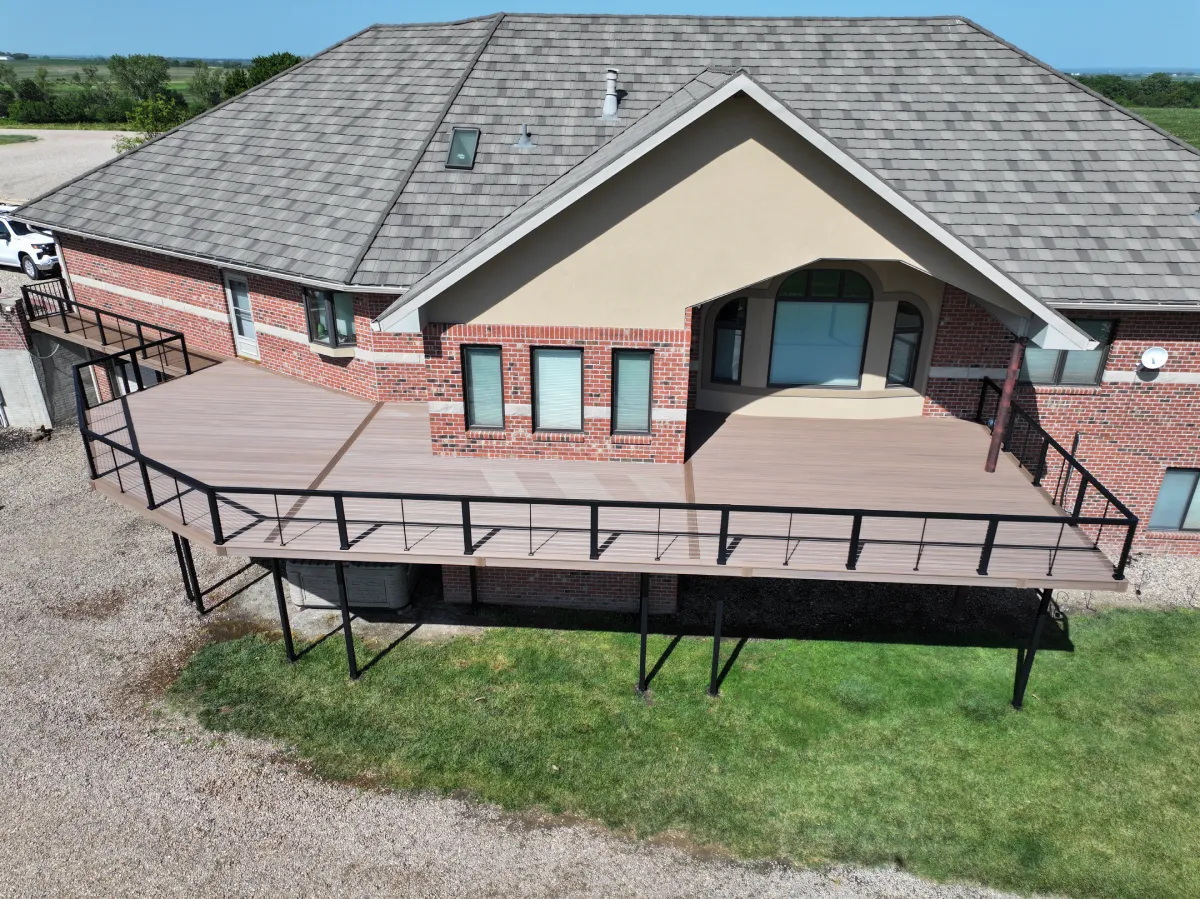 aerial-view-of-the-residential-decking-with-glass-railing-and-a-wide-gray-roof-in-omaha-ne