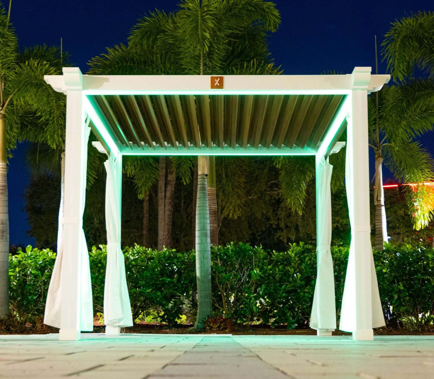 cabana-with-lighting-on-a-paver-with-grass-and-trees-on-the-background-in-omaha-ne