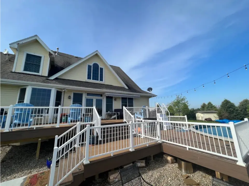 composite-multi-level-deck-and-white-railing-with-outdoor-furniture-and-a-pool-in-a-omaha-ne