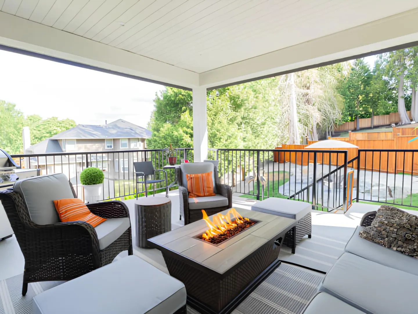 covered-deck-with-black-railing-and-a-firepit-with-outdoor-furniture-in-omaha-ne