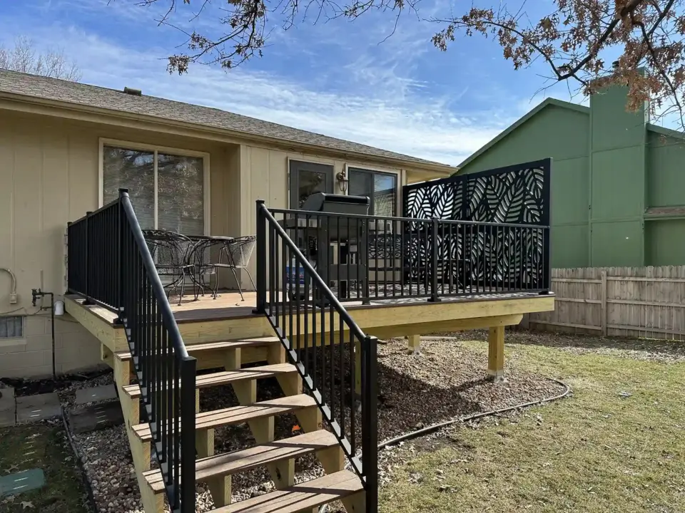 custom-raised-deck-with-black-railing-and-black-privacy-screen-in-omaha-ne