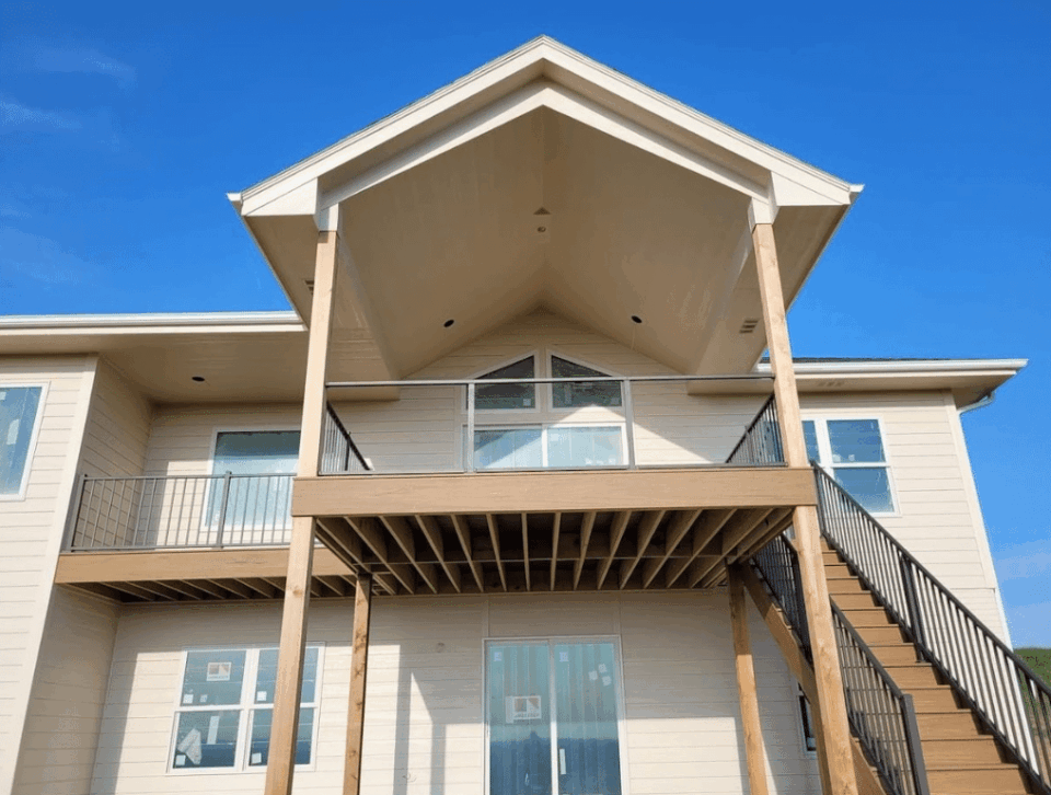 elevated-covered-deck-with-deck-railing-glass-panels-and-steps-in-omaha-ne