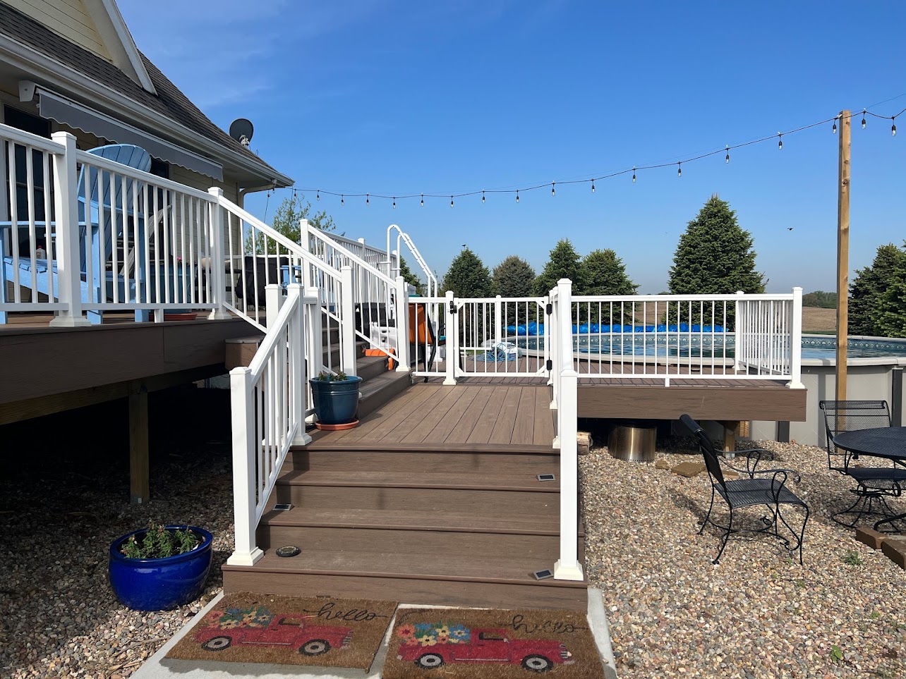 multi-level-residential-deck-with-white-railing-and-a-swimming-pool-in-omaha-ne