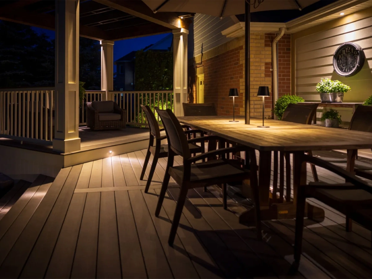 outdoor-dining-deck-with-lighting-on-the-ceiling-and-the-stair-steps-with-a-porch-in-omaha-ne