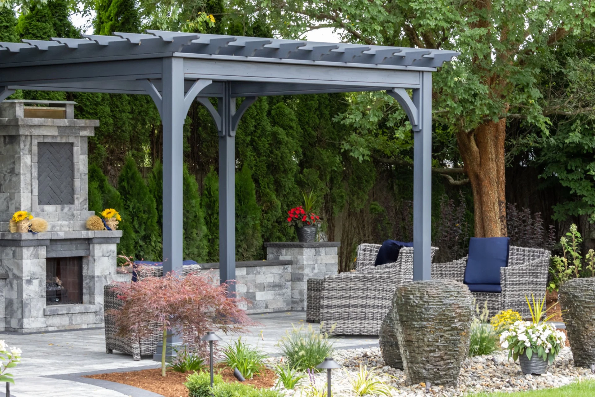 paver-patio-featuring-pergola-and-stone-fireplace-in-omaha-ne