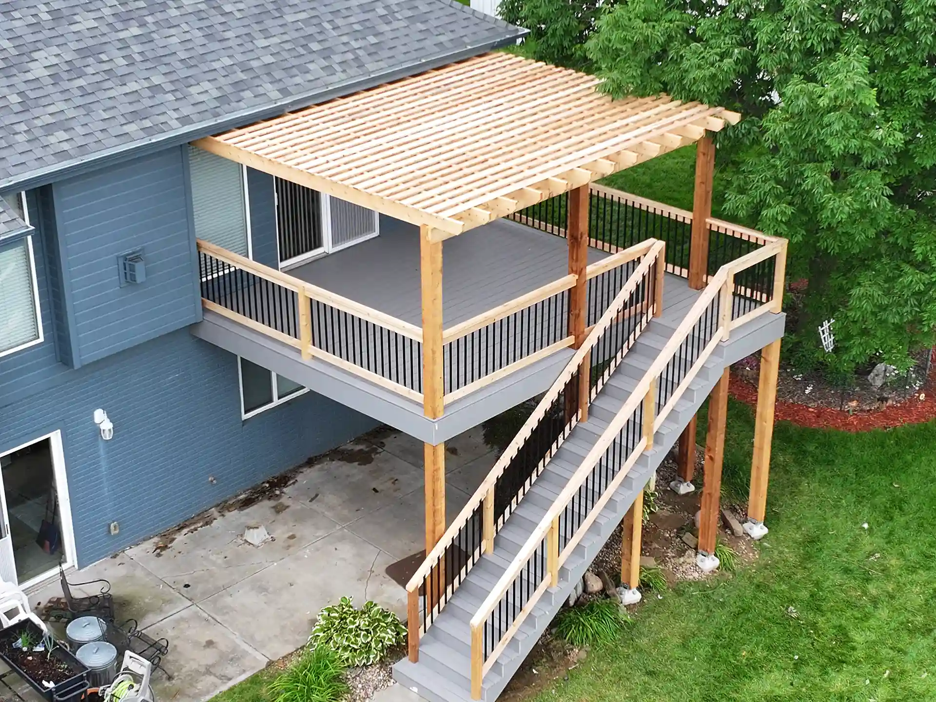 traditional wooden pergola on an elevated deck - pergola vs gazebo vs pavilion - How to choose for my home