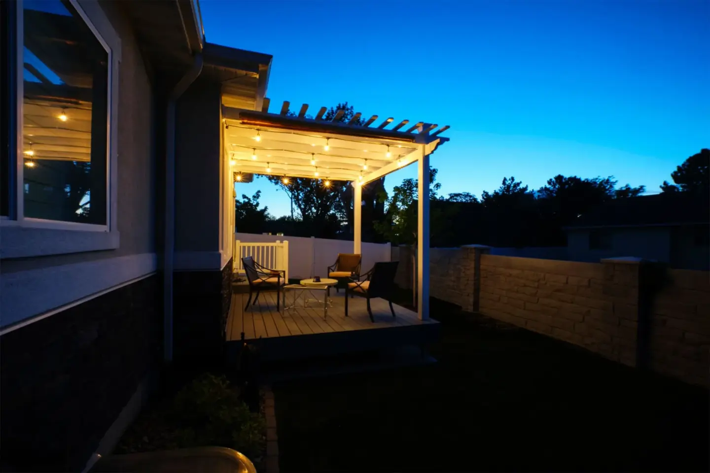 porch-and-custom-deck-with-outdoor-living-furniture-with-lighting-on-the-ceiling-of-porch-in-omaha-ne