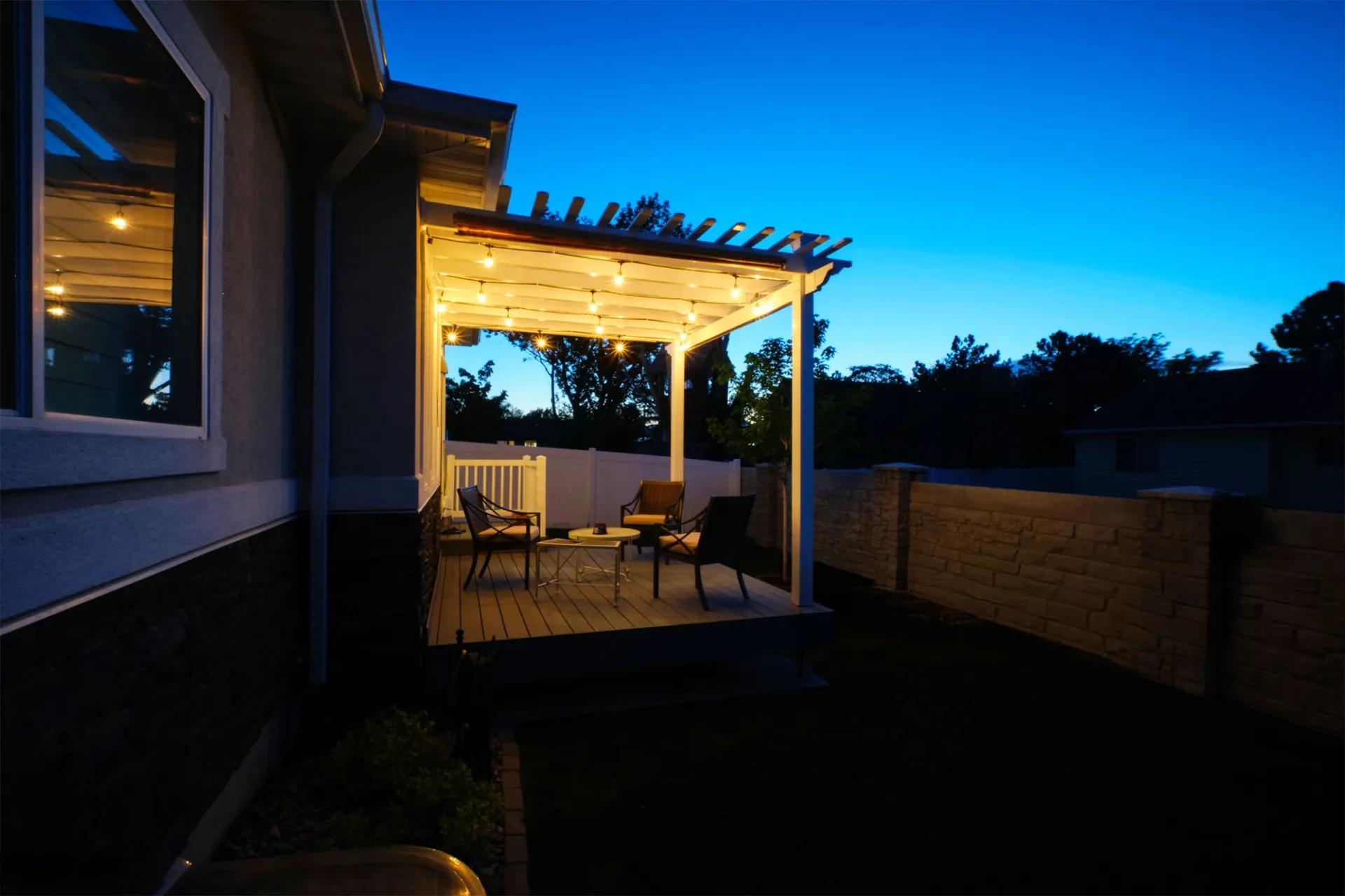 porch-and-custom-deck-with-outdoor-living-furniture-with-lighting-on-the-ceiling-of-porch-in-omaha-ne