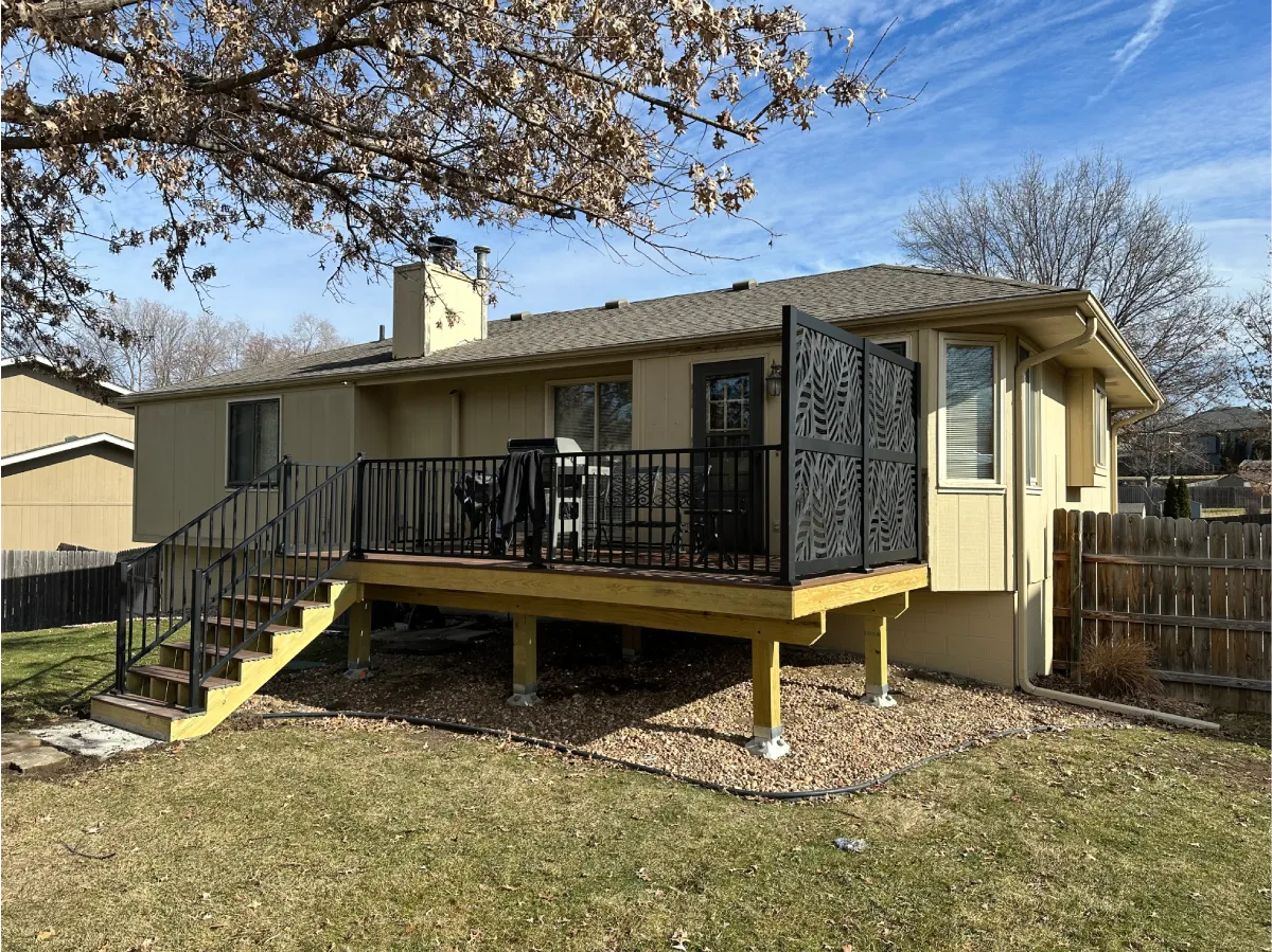 raised-residential-decking-with-black-metal-railing-and-a-black-privacy-screen-in-omaha-ne