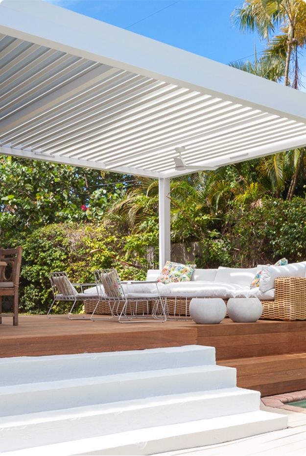 white-custom-louvered-pergola-on-the-residential-deck-with-couches-in-omaha-ne